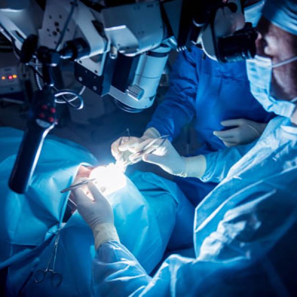 A team of surgeons performing brain surgery to remove a tumor.