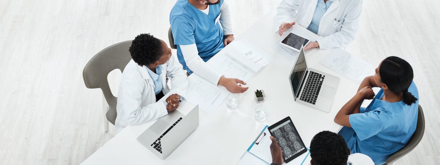 High angle shot of a group of medical practitioners having a meeting in a hospital boardroom