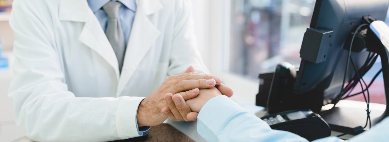 Pharmacist doctor supporting customer client buyer, listening attentively to her medical complaints