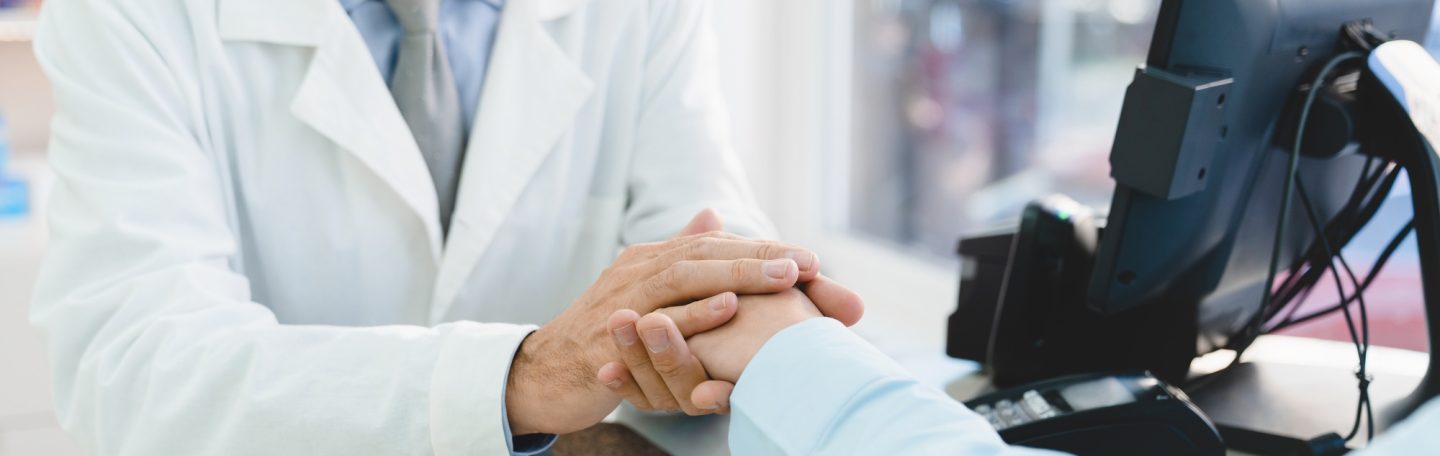 Pharmacist doctor supporting customer client buyer, listening attentively to her medical complaints